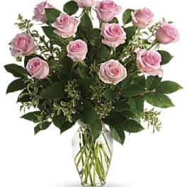 Pink roses arranged in a clear glass vase