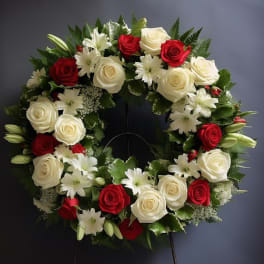 Circular wreath of red and white roses with white lilies
