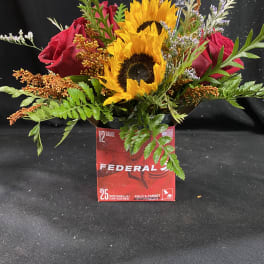 Bouquet of sunflowers and red roses in a red Federal box