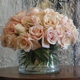 Bouquet of pale pink roses in a clear glass vase