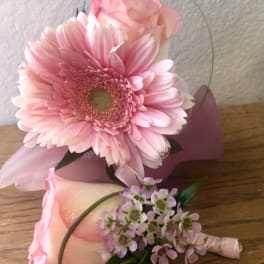 Pink gerbera daisy bouquet with a rose boutonniere