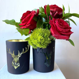 Red roses with green filler in black cups