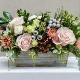Pink roses and mixed flowers in a rectangular wooden planter