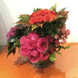 Bouquet of pink and orange roses in a glass vase