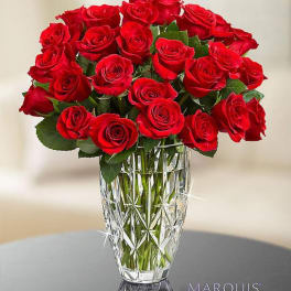 Red roses arranged in a cut crystal vase