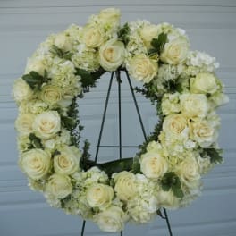 Cream rose and hydrangea wreath on a metal stand