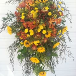 Tall standing floral spray with yellow and orange flowers