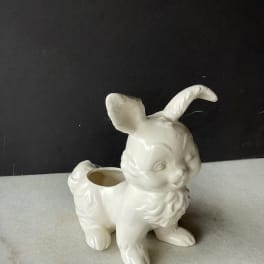 White ceramic bunny-shaped planter on a gray surface