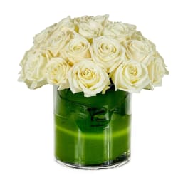 White roses arranged in a clear glass vase