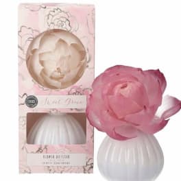 Pink flower diffuser with a white ribbed base and matching box