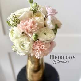 Blush and white bouquet in a gold vase