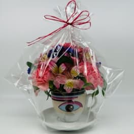 Wrapped flower arrangement in a mug with an eye design