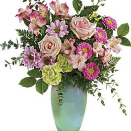 Pink and lavender flowers in a green vase