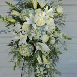 Tall white floral standing spray with lilies and roses