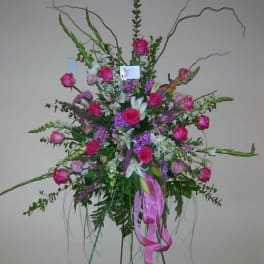 Tall pink and purple floral spray with ribbon accents
