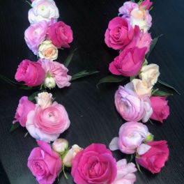Pink and white floral wrist corsages arranged in a circle