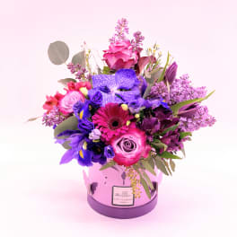 Pink and purple mixed bouquet in a round lavender box
