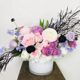 Bouquet of pink and purple roses in a white vase