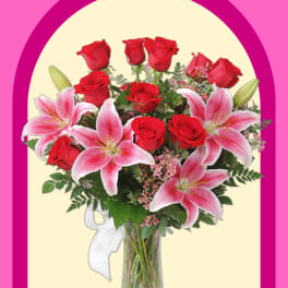Bouquet of red roses and pink lilies in a glass vase