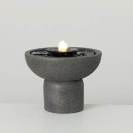 Gray tabletop fountain with a small flame in the center