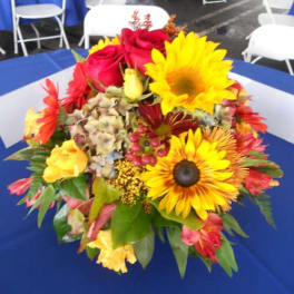 Bright mixed bouquet with sunflowers and red roses