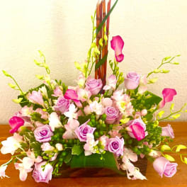 Pink and lavender rose arrangement with white and magenta calla lilies