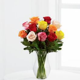 Mixed-color roses arranged in a clear glass vase