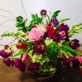 Bouquet of pink and purple flowers in a glass vase