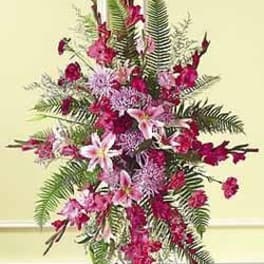 Tall pink and fuchsia standing spray with lilies and chrysanthemums on an easel