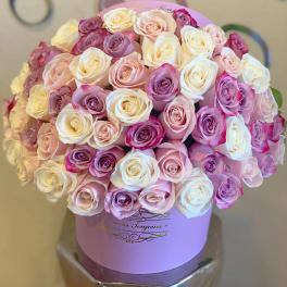 Bouquet of pink, white, and lavender roses in a lavender hat box