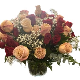 Bouquet of red and peach roses in a glass vase