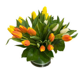 Bouquet of yellow and orange tulips in a glass vase
