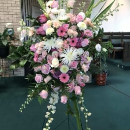 Large pink and white floral standing spray on an easel