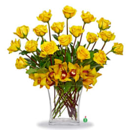 Tall arrangement of yellow roses and yellow orchids in a clear glass rectangular vase