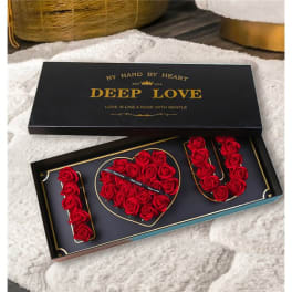 Black gift box with red roses arranged as "I LOVE U"
