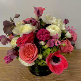 Mixed pink and white bouquet in a dark glass vase