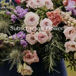 Mixed bouquet of pale pink and purple flowers with spiky greenery