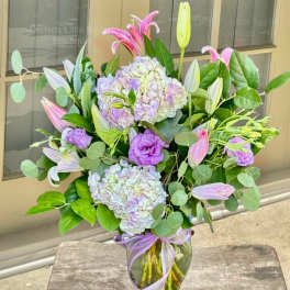 Lavender and pink bouquet with lilies and hydrangeas in a glass vase