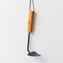 Wooden hanging tool with a black metal blade