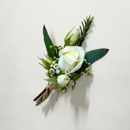 Small white rose boutonniere with green buds and leaves