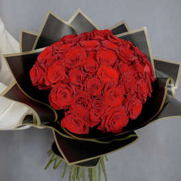Bouquet of red roses wrapped in black paper