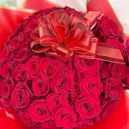Large bouquet of red roses with a decorative ribbon bow