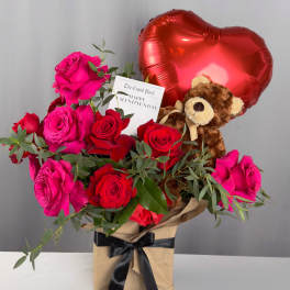 Bouquet of red and pink roses with a teddy bear and heart balloon