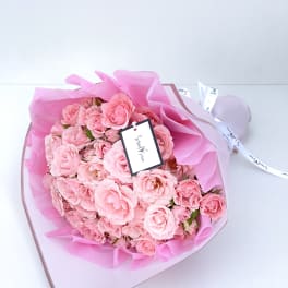 Bouquet of pink roses wrapped in pink paper