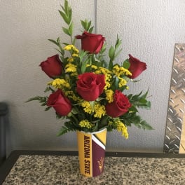 Red roses and yellow filler flowers in an Arizona State cup