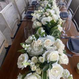 Long table centerpiece with white roses and greenery