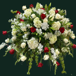 Large floral spray of red and white roses with white lilies and hydrangeas