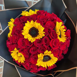 Bouquet of red roses with yellow sunflowers wrapped in black paper