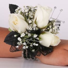White rose wrist corsage with baby's breath and black ribbon