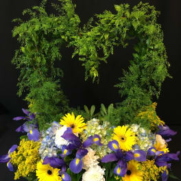 Basket arrangement with yellow daisies, purple irises, and blue hydrangeas